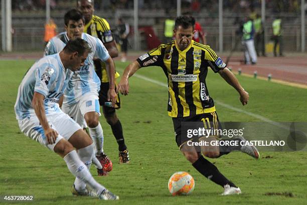 Venezuelan Deportivo Tachira's Cesar Gonzalez tries to get past Argentina Racing Club's, Ivan Pillud , during their Libertadores Cup football match...