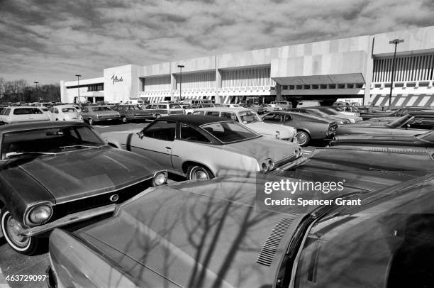 View of a parking lot full of holiday shoppers' automobiles, outside a Filene's department store, Chestnut Hill Mall, Newton, Massachusetts, 1978.