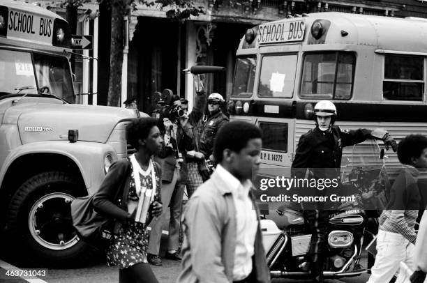 Bused black schoolchildren arrive with police escort at South Boston High School during court-ordered desegregation crisis, South Boston,...