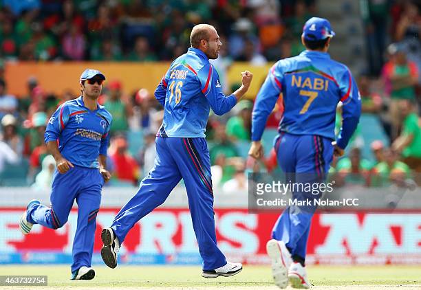 Merwais Ashraf of Afghanistan celebrates getting the wicket of Anamul Haque of Bangladesh during the 2015 ICC Cricket World Cup match between...