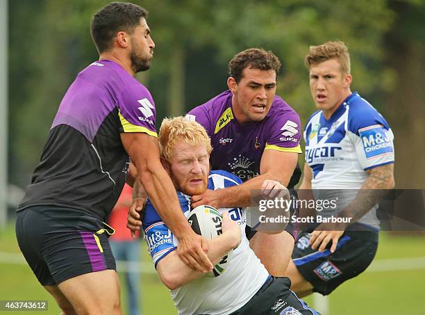 James Graham of the Bulldogs is tackled by Dale Finucane of the Storm during a joint NRL training session with the Melbourne Storm and Canterbury...