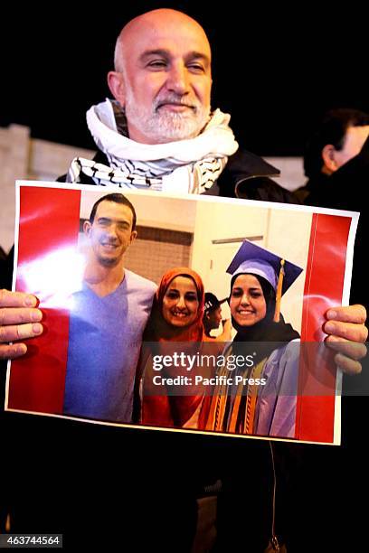 Man holds up a poster of the three slain Muslim students from Chapel Hill during a vigil in the West Bank city of Beit Sahur. Following another video...