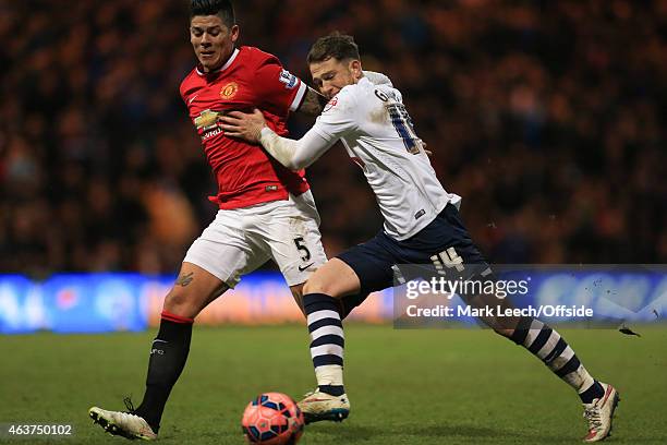 Marcos Rojo of Manchester United tangles with Joe Garner of Preston North End during the FA Cup Fifth round match between Preston North End and...