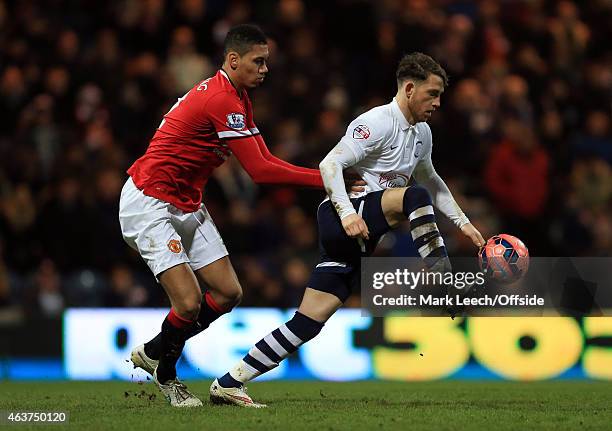 Chris Smalling of Manchester United tangles with Joe Garner of Preston North End during the FA Cup Fifth round match between Preston North End and...