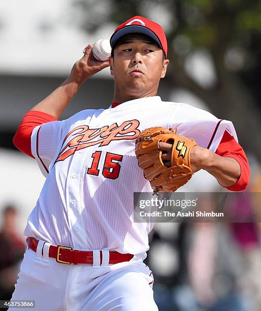 Hiroki Kuroda of Hiroshima Toyo Carp throws during a warm-up during the spring camp at the Koza Shinkin Stadium on February 18, 2015 in Okinawa,...