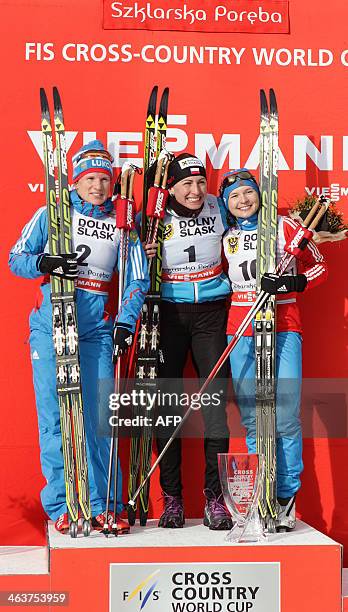 Russia's Yulia Tchekaleva, Poland's Justyna Kowalczyk and Russia's Julia Ivanova pose after winning the 10km mass start classic in the FIS Cross...