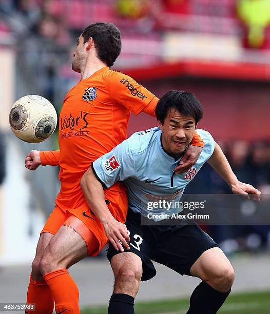 Shinji Okazaki of Mainz is challenged by Vito Plut of Saarbruecken during the friendly match between 1. FSV Mainz 05 and 1. FC Saarbruecken at...