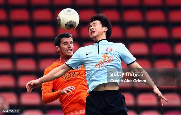 Shinji Okazaki of Mainz is challenged by Vito Plut of Saarbruecken during the friendly match between 1. FSV Mainz 05 and 1. FC Saarbruecken at...