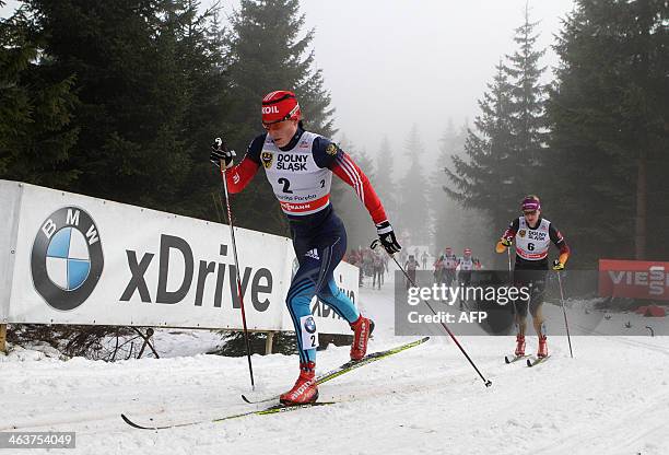 Russia's Yulia Tchekaleva and Germany's Denise Herrmann compete during the 10km mass start classic in the FIS Cross Country Skiing World Cup 2014 on...