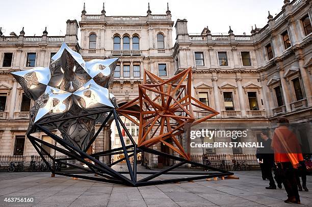 Sculpture by US artist Frank Stella entitled 'Inflated Star and Wooden Star', 2014 is seen in the courtyard at the Royal Academy of Arts on February...