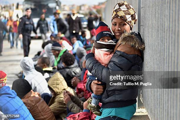 Immigrants wait to board a ship on February 18, 2015 in Lampedusa, Italy. Hundreds of migrants have recently arrived in Lampedusa fleeing the attacks...