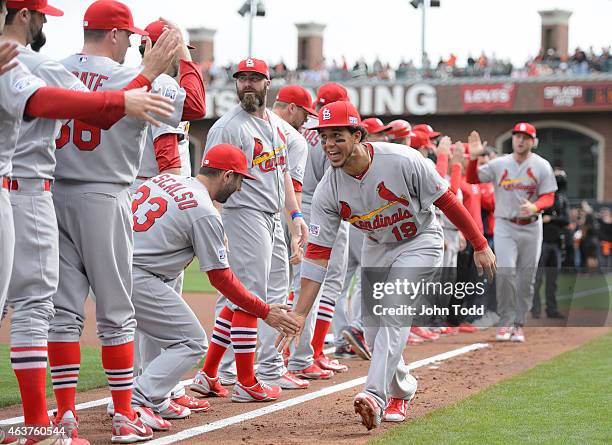 Jon Jay of the St. Louis Cardinals is greeted by teammates during player introductions before Game 3 of the NLCS against the San Francisco Giants at...