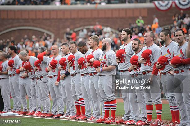 Members of the St. Louis Cardinals are seen on the base path during the singing of the National Anthem before during Game 3 of the NLCS against the...