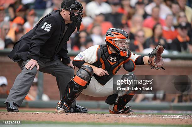 Buster Posey of the San Francisco Giants catches during Game 3 of the NLCS against the St. Louis Cardinals at AT&T Park on Tuesday, October 14, 2014...