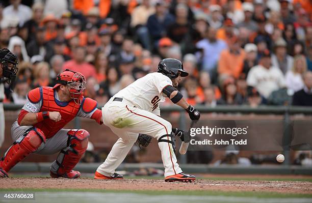 Gregor Blanco of the San Francisco Giants sacrifice bunts in the bottom of the 10th inning of Game 3 of the NLCS against the St. Louis Cardinals at...