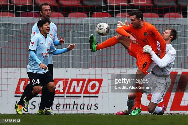 Patrick Schmidt of Saarbruecken is challenged by goalkeeper Dario Kresic and Joo-Ho Park of Mainz during the friendly match between 1. FSV Mainz 05...
