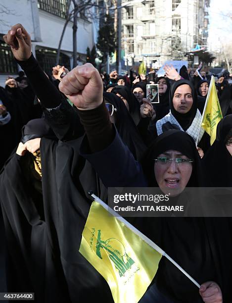 Iranian women hold Hezbollah flags lag during a demonstration on February 18 near the Swiss embassy in Tehran, in solidarity with the three Muslim...