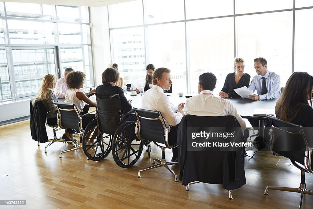 Big business meeting one person in wheelchair