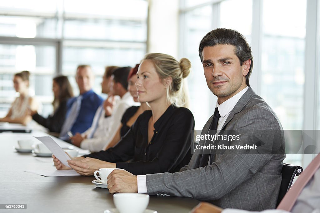 Portrait of handsome businessman at meeting