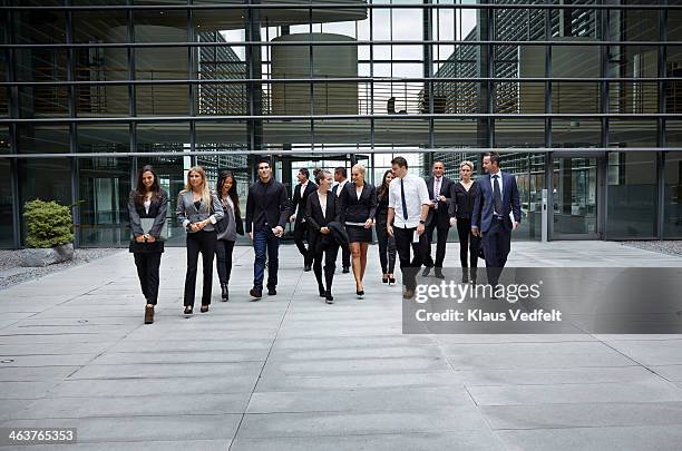 big group of business people walking from building - entrance building people stock-fotos und bilder