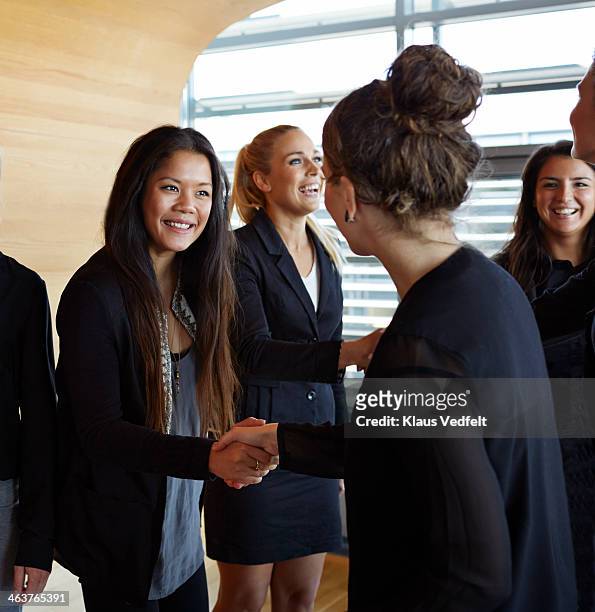 business people making handshakes before meeting - true events stockfoto's en -beelden