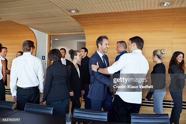 business people making handshake in meeting room - meeting room stockfoto's en -beelden