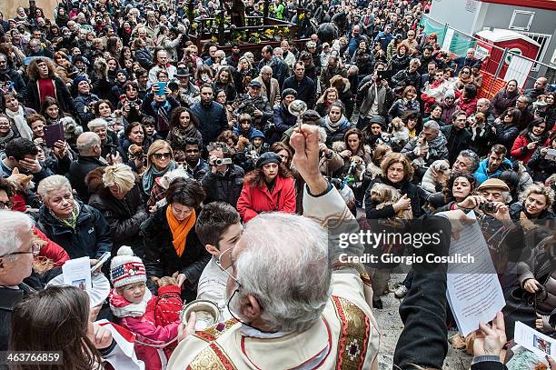 Priest blesses the crowd of faithful with their pets after a traditional mass for the blessing of animals at the Sant'Eusebio church on January 19,...