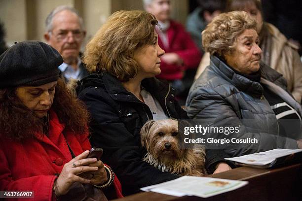 Dog and its owner attend a traditional mass for the blessing of animals at the Sant'Eusebio church on January 19, 2014 in Rome, Italy. Every year...