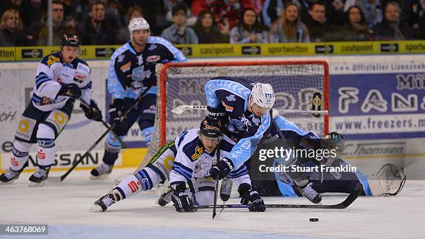 Nico Kraemmer of Hamburg challenges for the puck with Karl Stewart of Straubing during the DEL ice hockey match between Hamburg Freezers and...