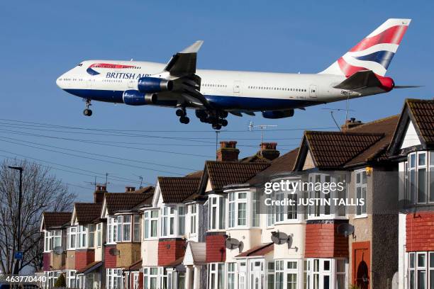 British Airways 747 aircraft flies over roof tops as it comes into lane at Heathrow Airport in west London on February 18, 2015. Heathrow's expansion...