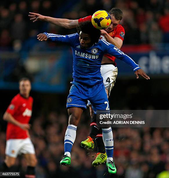 Chelsea's Brazilian midfielder Willian and Manchester United's English defender Phil Jones contest a high ball during the English Premier League...