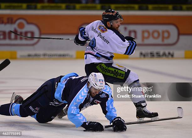 Marius Moechel of Hamburg challenges for the puck with Sebastian Osterloh of Straubing during the DEL ice hockey match between Hamburg Freezers and...