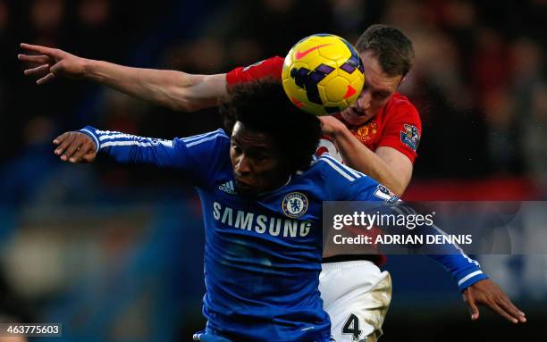 Chelsea's Brazilian midfielder Willian and Manchester United's English defender Phil Jones contest a high ball during the English Premier League...