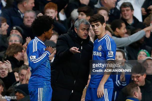 Chelsea's Portuguese manager Jose Mourinho talks with Chelsea's Brazilian midfielder Oscar and Chelsea's Brazilian midfielder Willian after the...