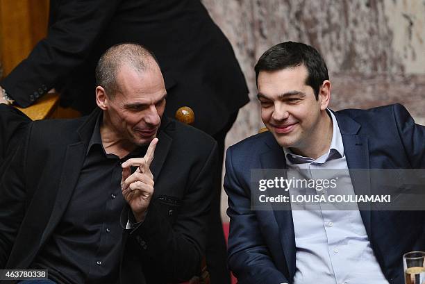 Greek Prime Minister Alexis Tsipras speaks with his Finance Minister Yianis Varoufakis during the vote for the president, at the Greek parliament in...