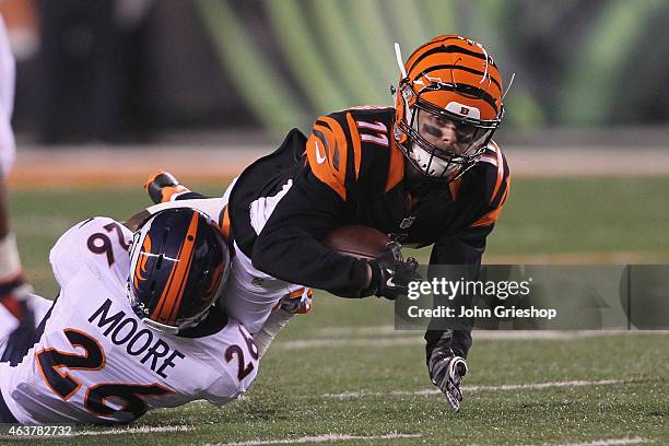 Dane Sanzenbacher of the Cincinnati Bengals runs the football upfield against Rahim Moore of the Denver Broncos during their game at Paul Brown...