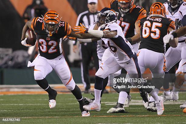 Jeremy Hill of the Cincinnati Bengals runs the football upfield against Rahim Moore of the Denver Broncos during their game at Paul Brown Stadium on...