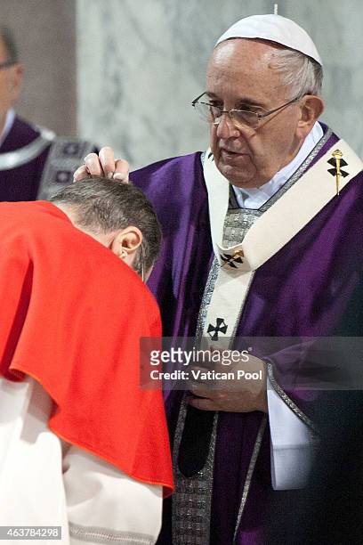 Pope Francis blesses with the ritual placing of ashes on the head of a cardinal during the Ash Wednesday service at the Santa Sabina Basilica on...