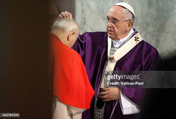 Pope Francis blesses with the ritual placing of ashes on the head of a cardinal during the Ash Wednesday service at the Santa Sabina Basilica on...