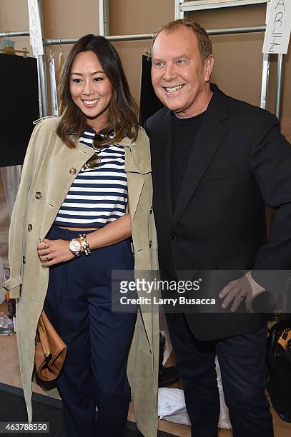 Aimee Song and designer Michael Kors pose for a photo backstage at the Michael Kors fashion show during Mercedes-Benz Fashion Week Fall 2015 at...