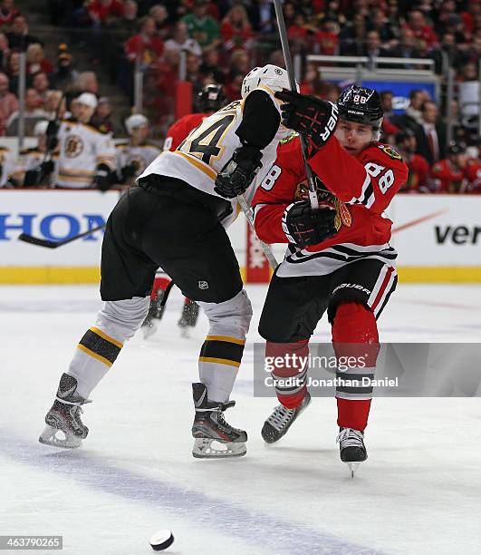 Patrick Kane of the Chicago Blackhawks collides with Carl Soderberg of the Boston Bruins at the United Center on January 19, 2014 in Chicago,...