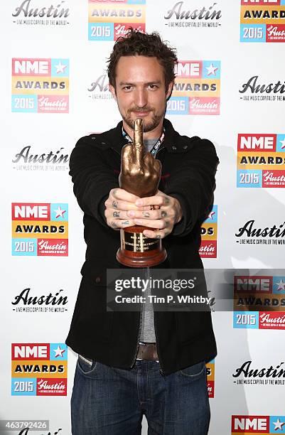 Frank Turner poses after picking up the Outstanding Contribution to Music award on behalf of the Tennage Cancer Trust in the winner's room at the NME...