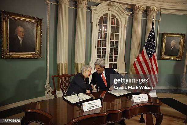 Secretary of State John Kerry and EPA Administrator Gina McCarthy participate in a signing ceremony at the State Department February 18, 2015 in...