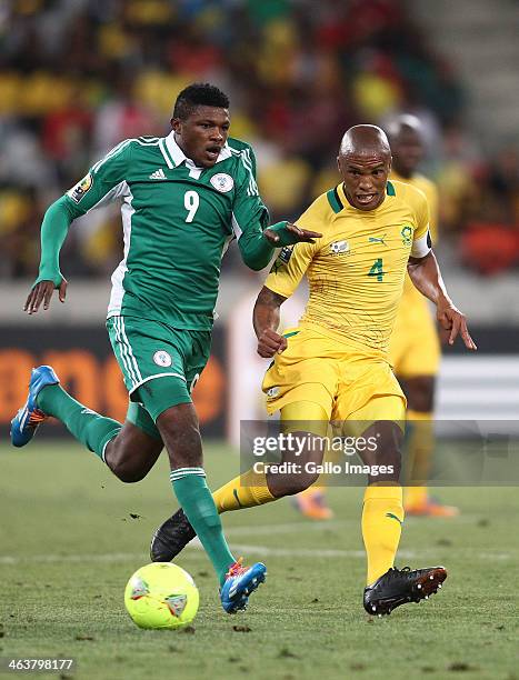 Fuad Salami of Nigeria fails to make the tackle as South African captain Benett Nthete gets his pass away during the 2014 African Nations...