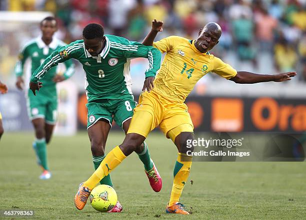 Rabiu Ali of Nigeria and Hlompho Kekana of South Africa challenge for possession during the 2014 African Nations Championship match between South...