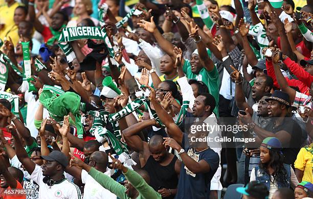 Nigerian fans celebrate their second goal during the 2014 African Nations Championship match between South Africa and Nigeria at Cape Town Stadium on...