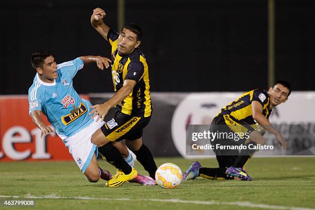 Irven Avila of Sporting Cristal competes for the ball with Luis Cabral and Tomas Bartomeus of Guarani during a match between Guarani and Sporting...