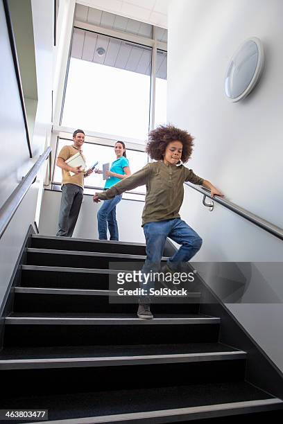 young boy running down stairs - kid looking down stock pictures, royalty-free photos & images