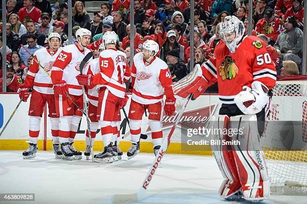 Danny DeKeyser, Jonathan Ericsson, Riley Sheahan and Darren Helm of the Detroit Red Wings celebrate with Tomas Tatar after scoring on goalie Corey...