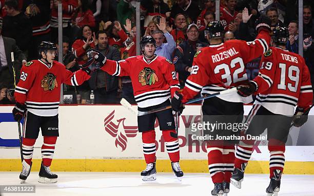Brandon Saad of the Chicago Blackhawks celebrates his second period goal with Kyle Cumiskey, Michal Rozsival and Jonathan Toews against the Detroit...